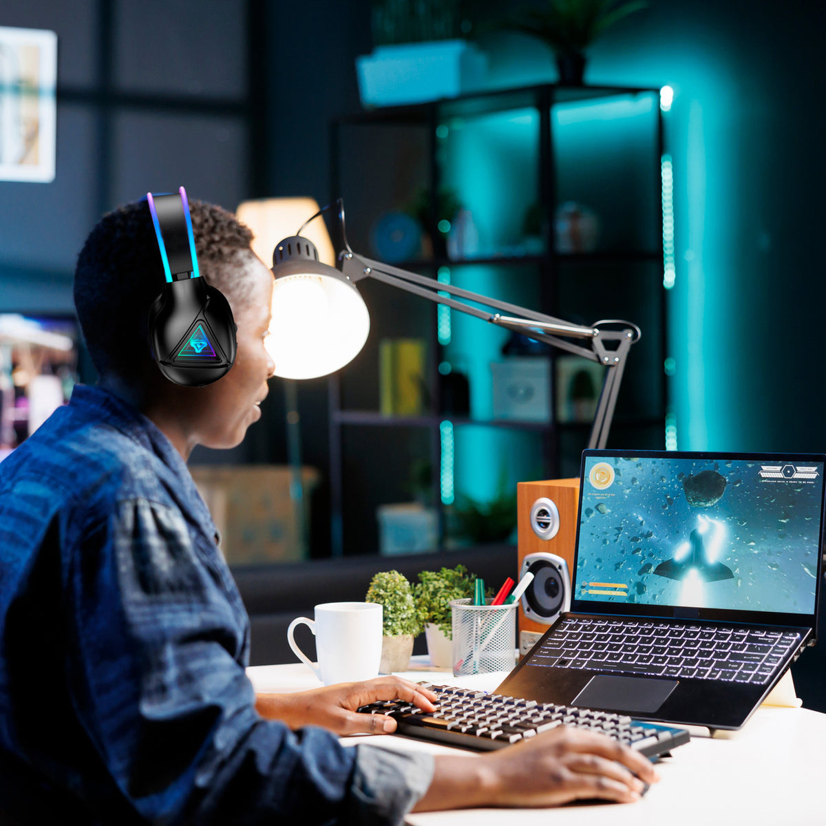 Laser RGB Infinity gaming headphones worn by woman working from home on a laptop
