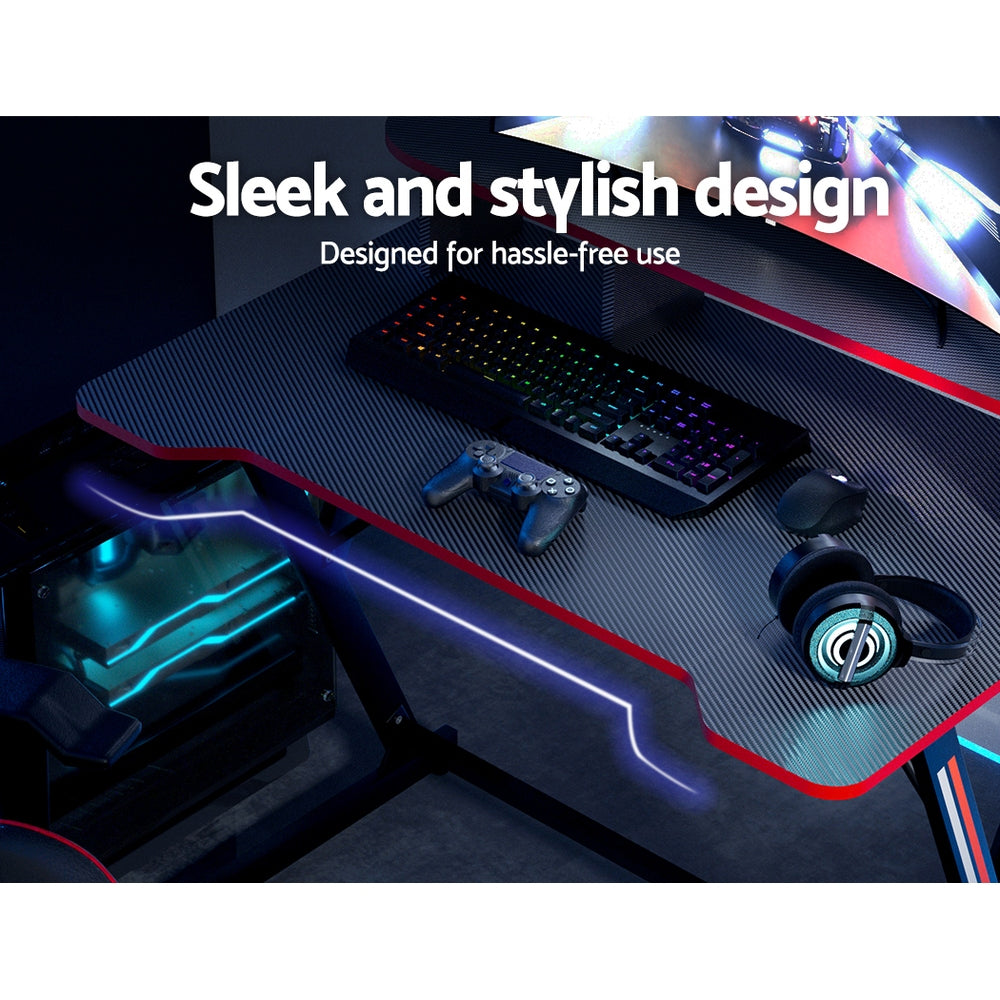 Top-down view of Artiss 100cm gaming desk carbon-fibre desktop with keyboard, controller and headphones