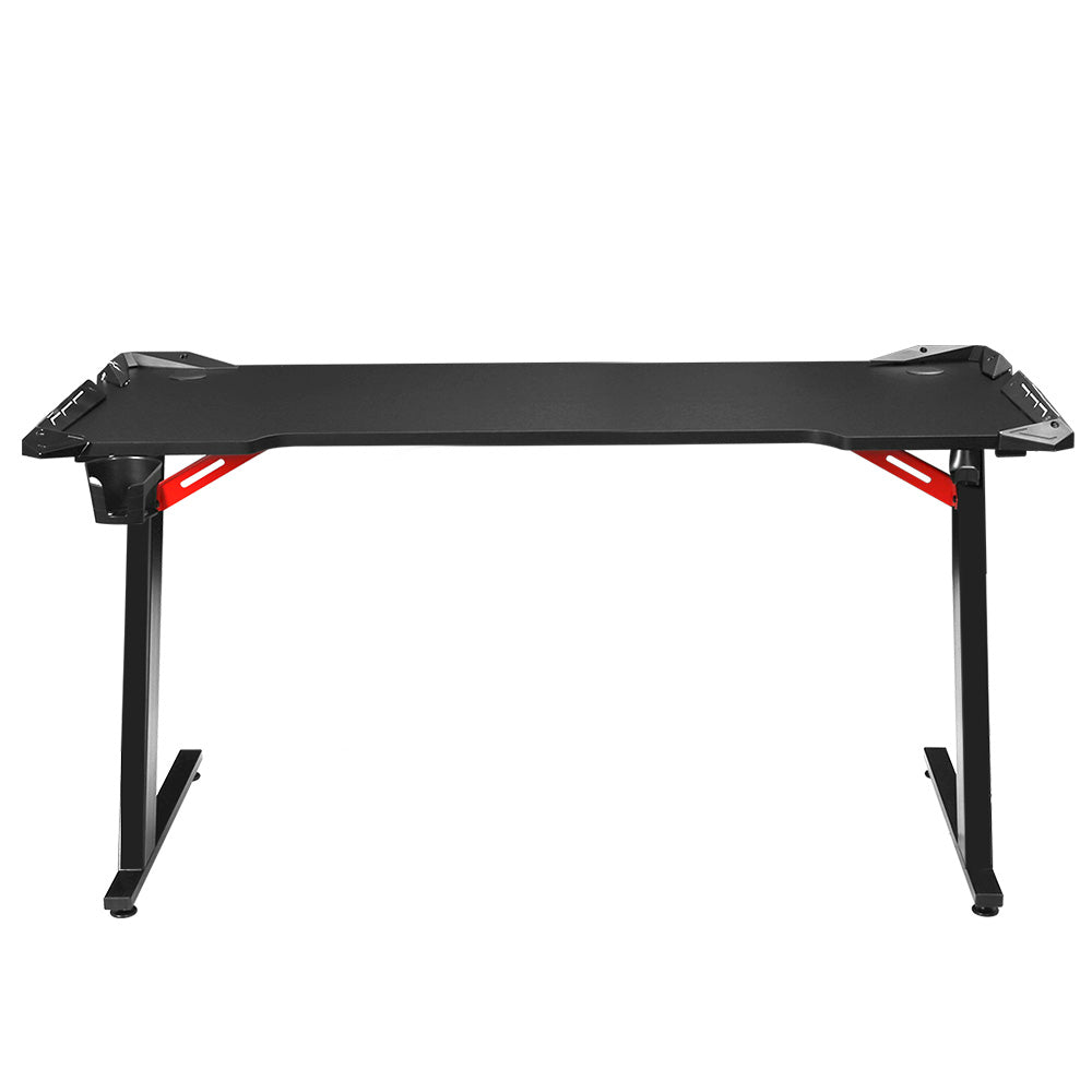 Artiss 140cm RGB gaming desk front-on view in black with curved desktop and red Z-frame supports