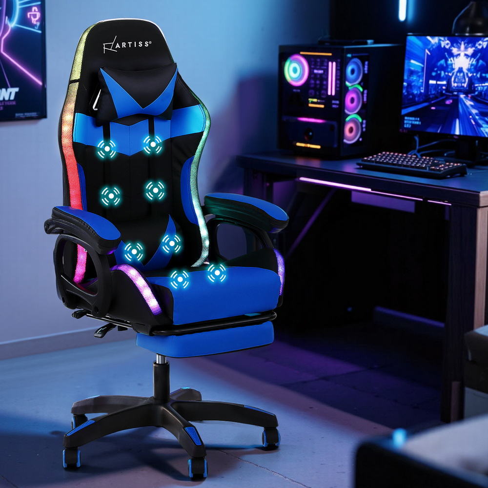 Artiss blue RGB LED gaming chair shown in a dark gaming room with PC tower and dual monitors