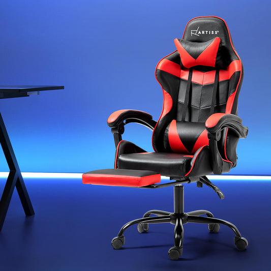 Artiss black and red gaming chair with footrest extended beside a desk in a blue-lit gaming room
