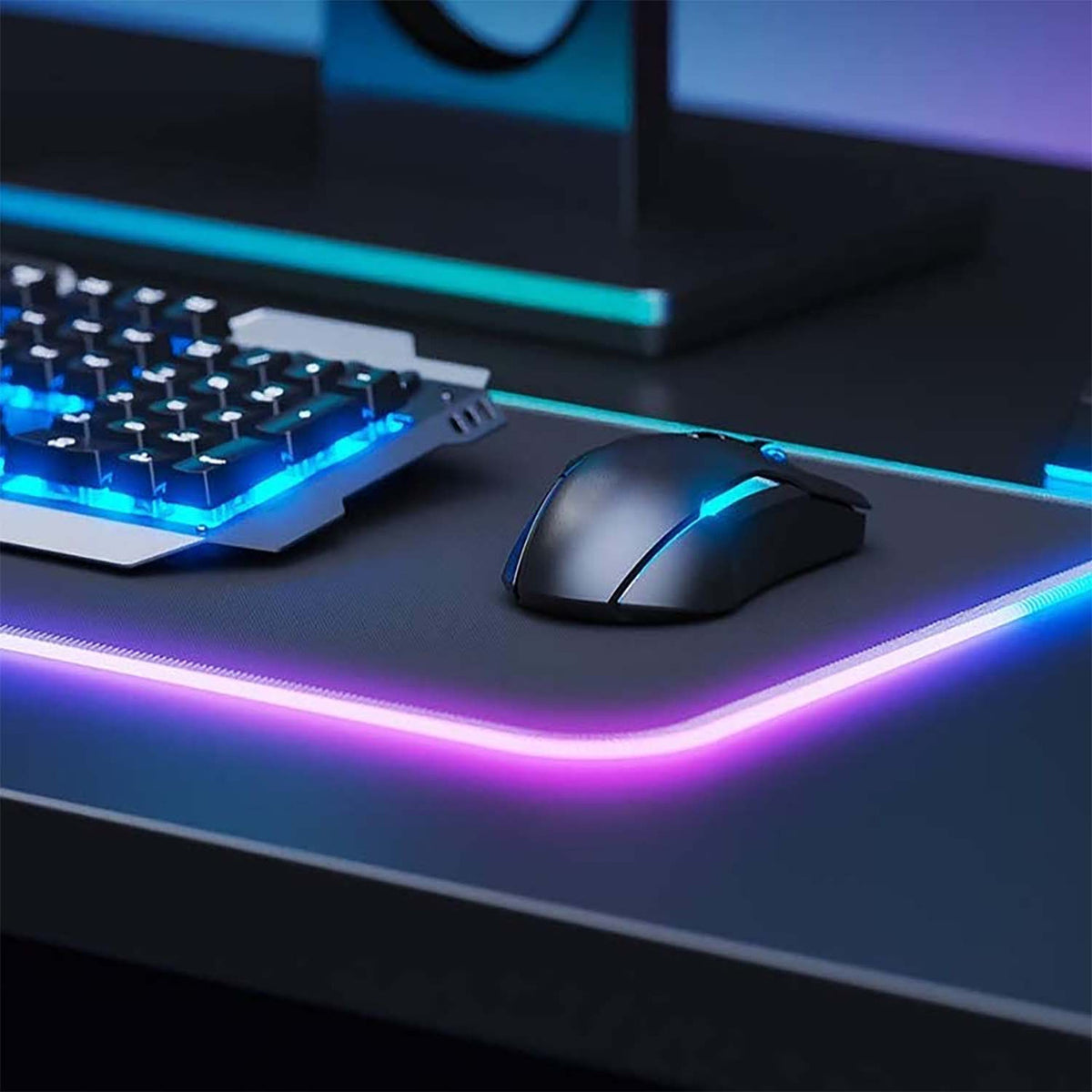 Laser RGB LED gaming mouse pad lit pink and purple under mouse and mechanical keyboard, close-up