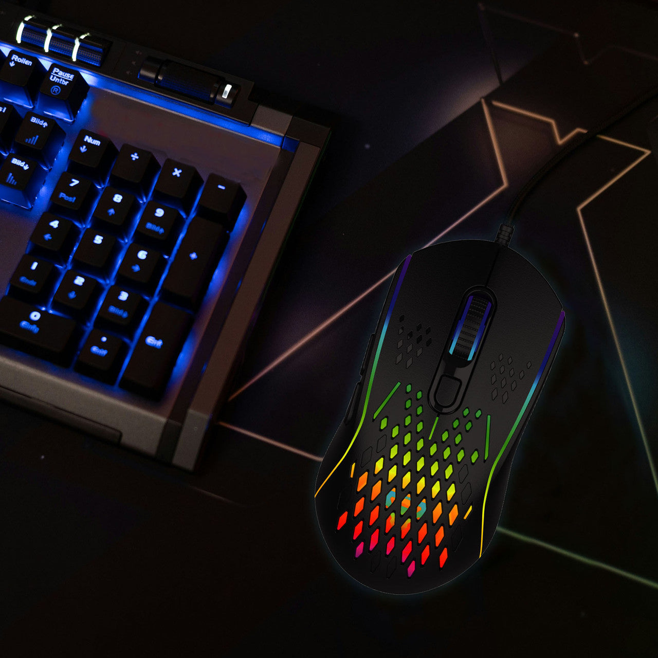 Laser RGB lightweight gaming mouse in black on desk next to blue backlit numpad keyboard, top view
